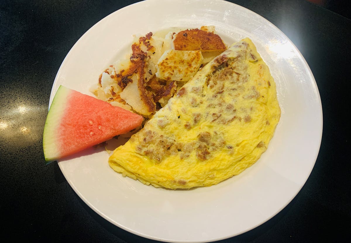 Omelet with home fries and fruit from House of Omelets in Cape Coral